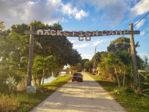 mack's fish camp entrance, sign, dirt road,